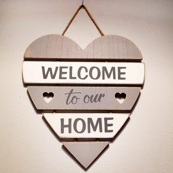 White and grey slated heart shaped wooden sign with the text 'Welcome to our home'