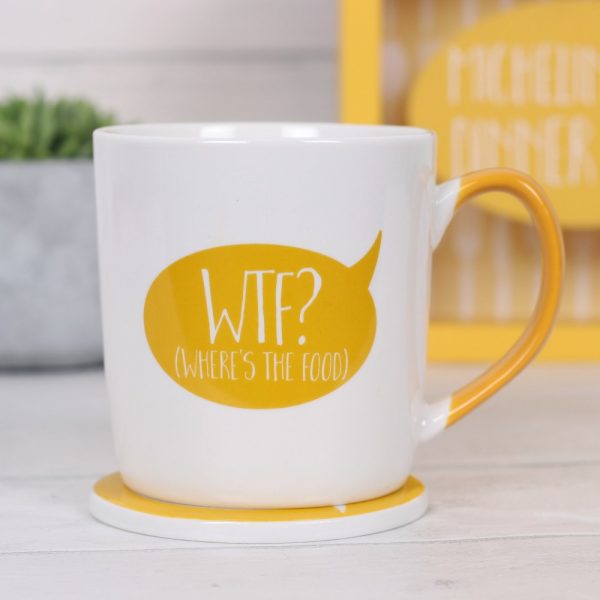 White mug with mustard yellow handle and speech bubble with a coaster featuring a cutlery set