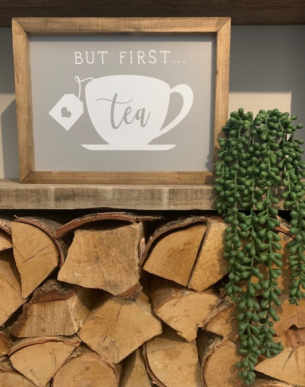 Handmade on a walnut stained frame. With a cup and saucer design with the slogan; But First...Tea