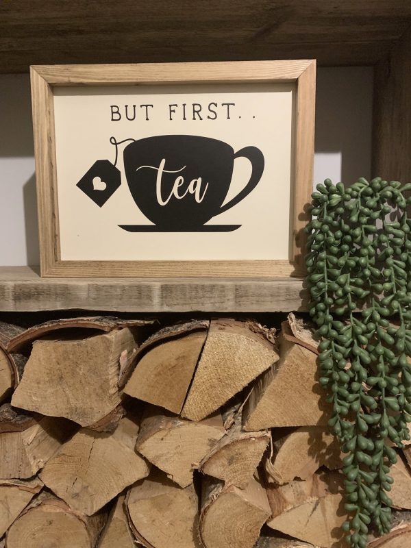 Handmade on a walnut stained frame. With a cup and saucer design with the slogan; But First...Tea