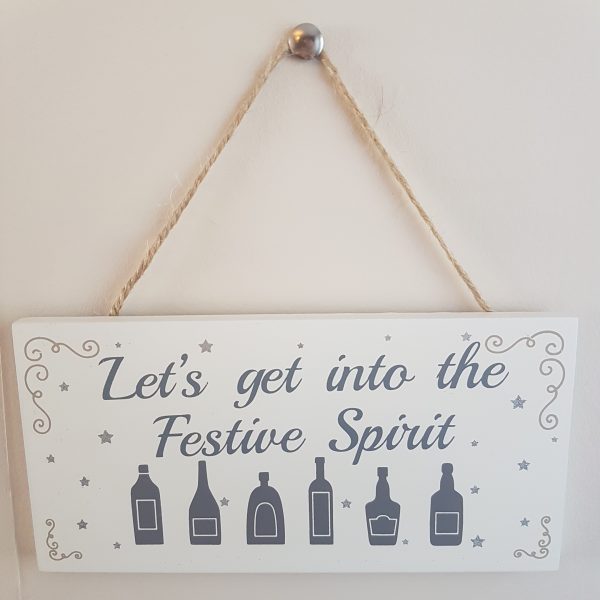 White plaque with grey text 'Let's get into the festive spirit'
