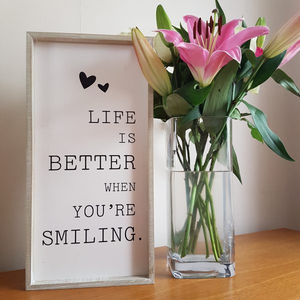 Wooden rustic framed sign with the quote 'Life Is Better When You're Smiling'