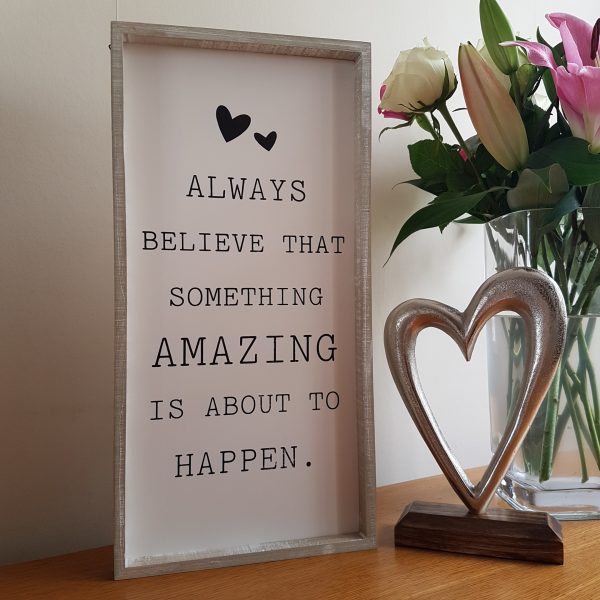 Wooden sign with rustic frame and the quote 'Always Believe Something Amazing Is About To Happen'