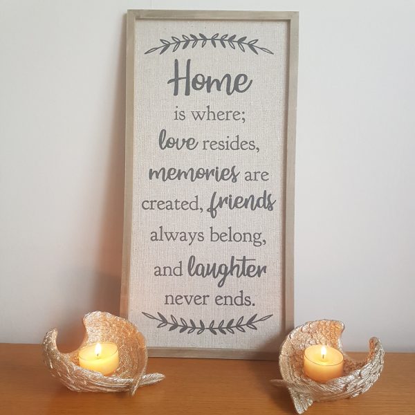 Large material canvas frame with the the text 'Home is where love resides, memories are created, friends always belong, and laughter never ends.'