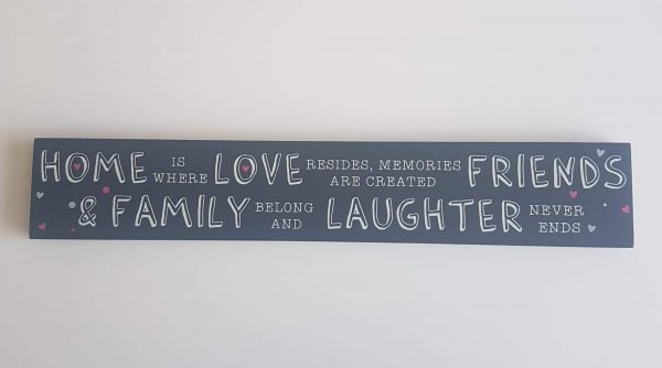 'Home is where love resides, memories are created, friends & family belong and laughter never ends' sign