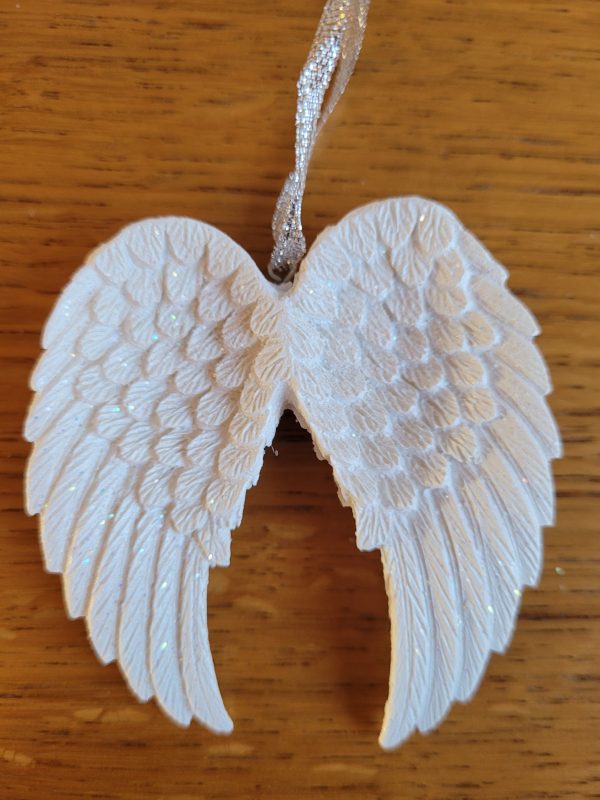 This pretty white double angel wing decoration features iridescent glitter for a sparkly effect when caught in the light. The wing comes on a metallic silver ribbon ready for hanging.