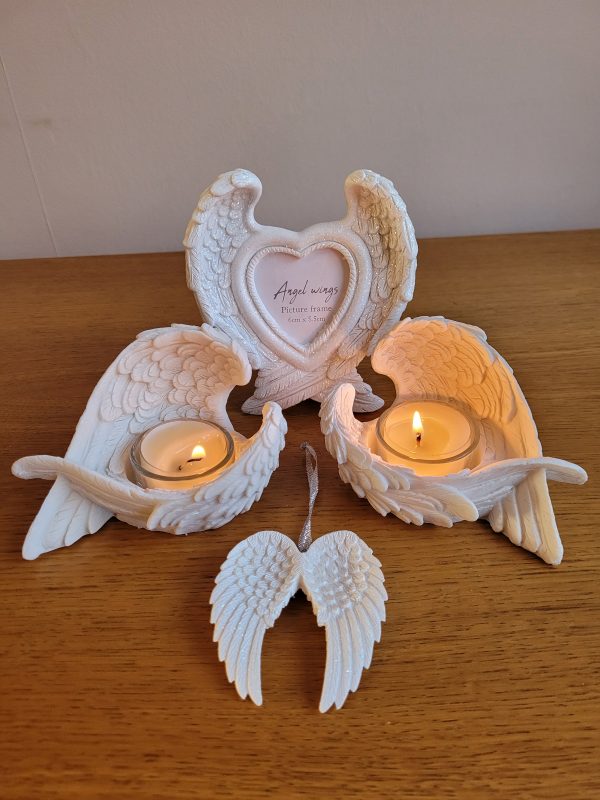 This pretty white double angel wing decoration features iridescent glitter for a sparkly effect when caught in the light. The wing comes on a metallic silver ribbon ready for hanging.