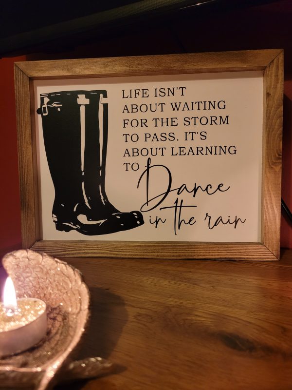 Handmade sign with a pair of Wellington Boots with a quote about Dancing in the rain