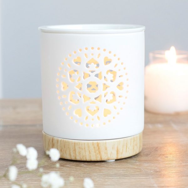 This white ceramic oil burner features a cut out mandala design with a wood-effect ceramic base. Place fragrance oil or wax melts into the built-in dish with a standard tealight inside to fill the home with calming fragrance.