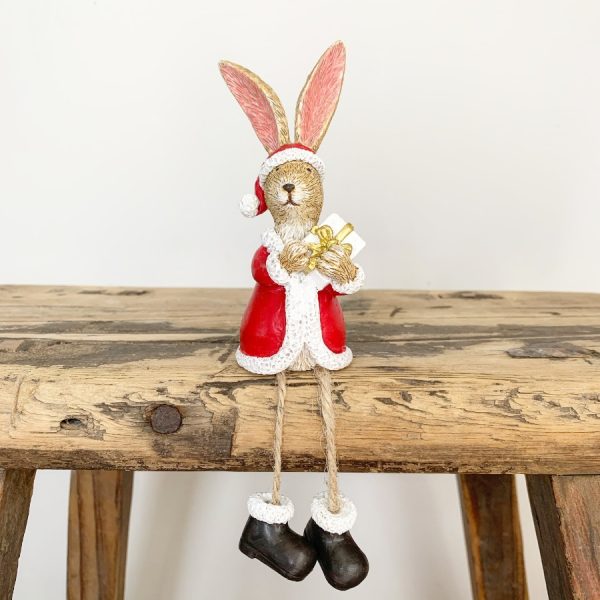 A wonderfully detailed shelf sitting rabbit dressed in a full Santa costume. Complete with wrapped gift.