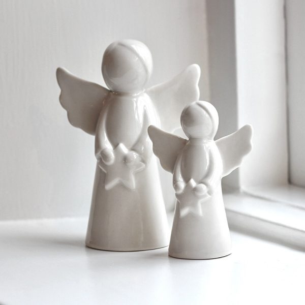 Complete with minimal features and a sleek white tone, these standing angel ornaments are a must have for any home  Set aside with any tones such as golds and blush pinks for a heavenly feel in your home 